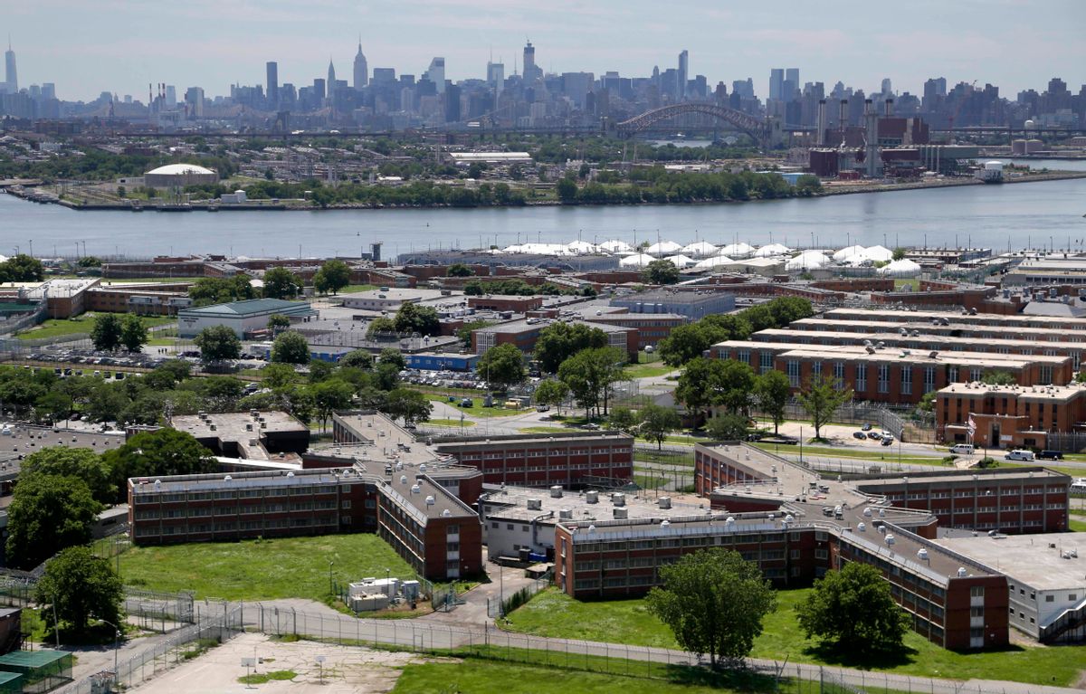 FILE - In a June 20, 2014, file photo, the Rikers Island jail complex stands in New York with the Manhattan skyline in the background. New York Mayor Bill de Blasio announced Friday, March 31, 2017, that he's developing a plan to shut down the massive jail within 10 years. (AP Photo/Seth Wenig, File) (AP)