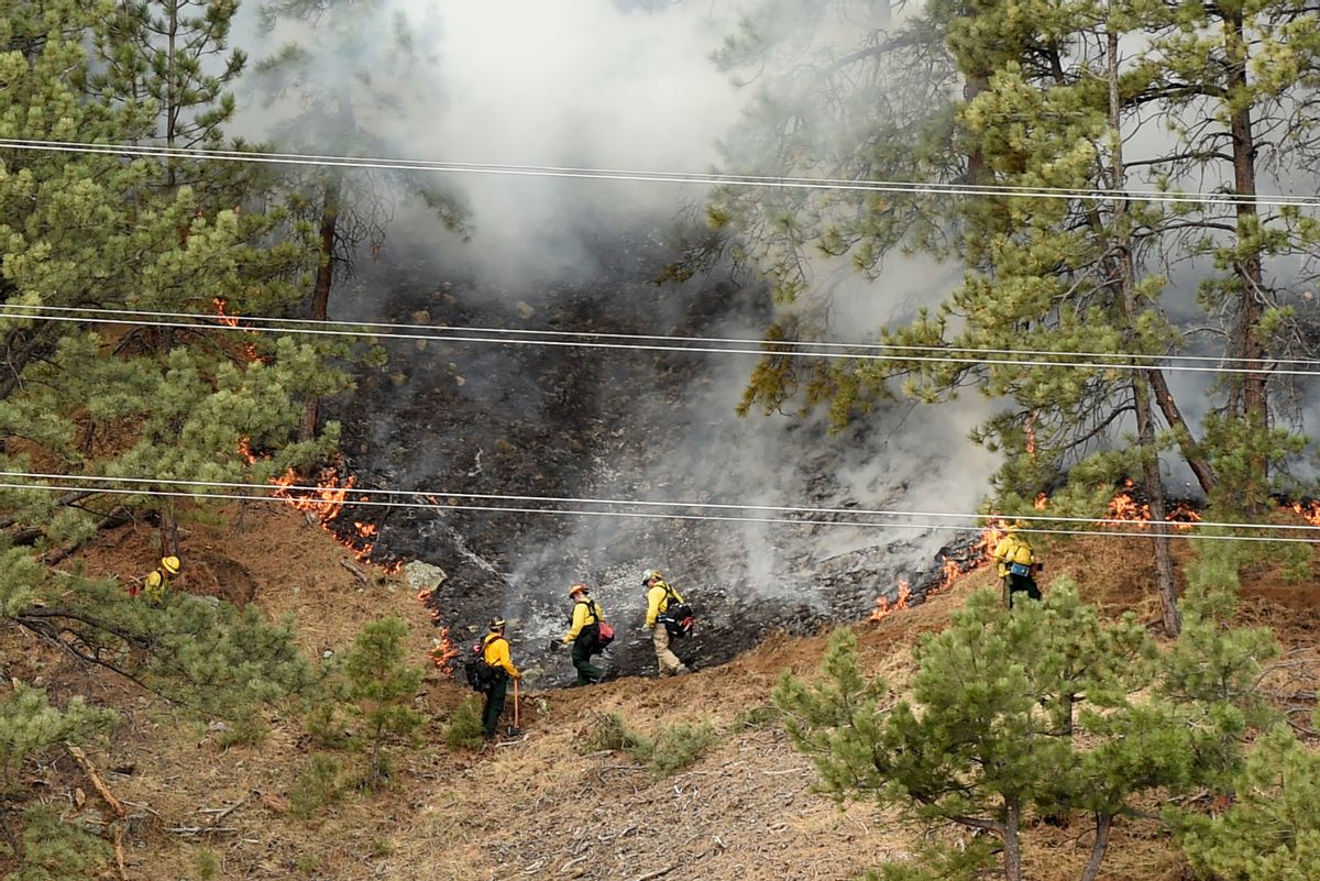 Crews battle the Sunshine Fire in the Sunshine canyon area of Boulder, Colo. on Sunday, March 19, 2017. The small wildfire forced people from their homes early Sunday and ignited dead trees that exploded into black plumes of smoke, authorities and residents said. (Jeremy Papasso/Daily Camera via AP) (AP)