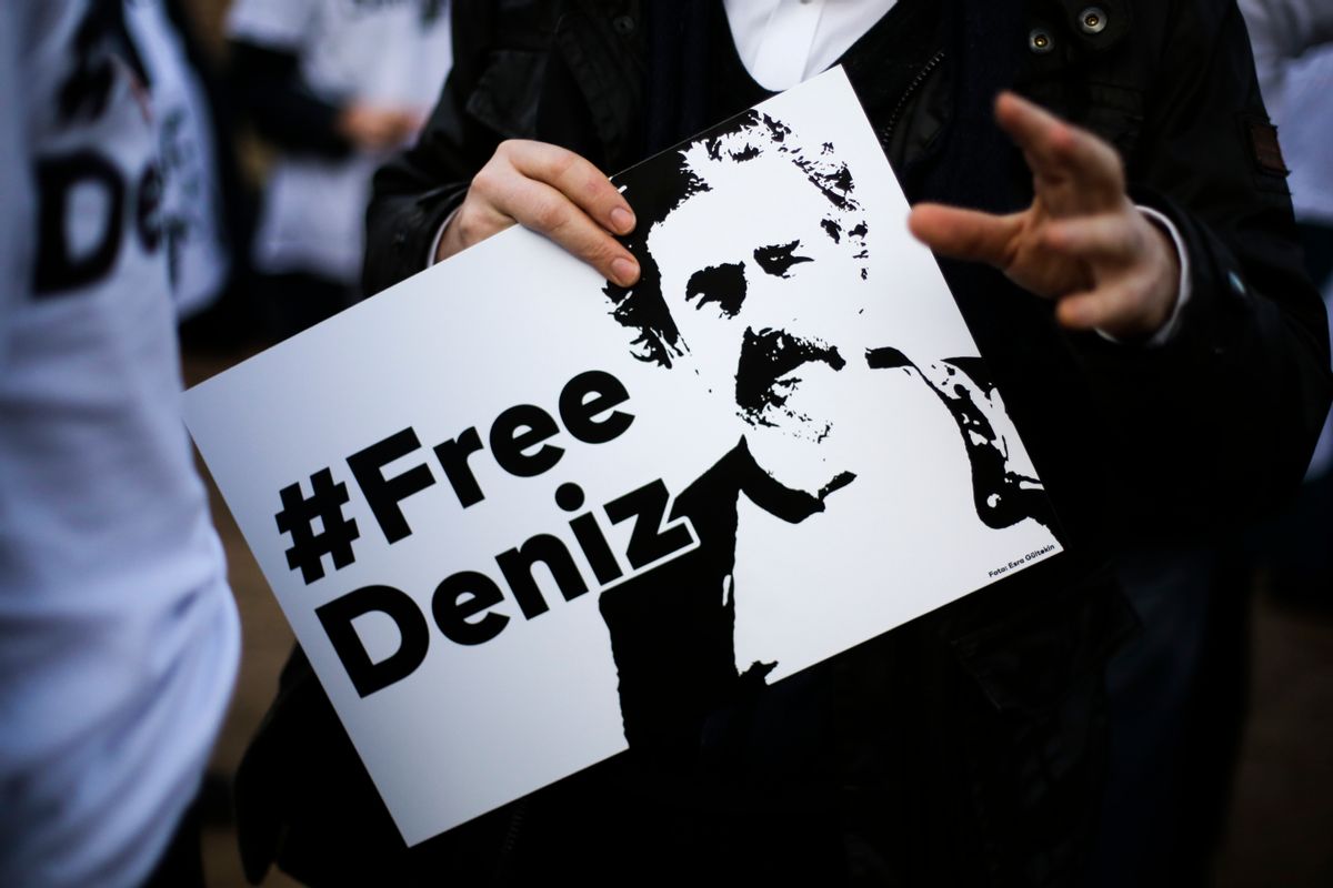 A man holds a poster with the slogan '#FREEDENIZ' during a protest in front of the Turkish embassy in Berlin, Tuesday, Feb. 28, 2017. Demonstrators protest against the police custody of Deniz Yucel, a correspondent in Turkey for the German daily newspaper 'Welt'. (AP Photo/Markus Schreiber) (AP)