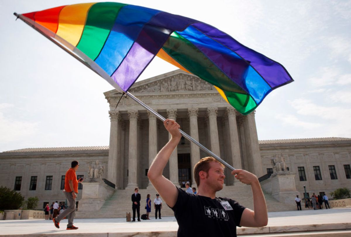 In a June 25, 2015 file photo, John Becker of Silver Spring, Md., waves a rainbow flag in support of gay marriage outside of the Supreme Court in Washington. (AP Photo/Jacquelyn Martin, File)