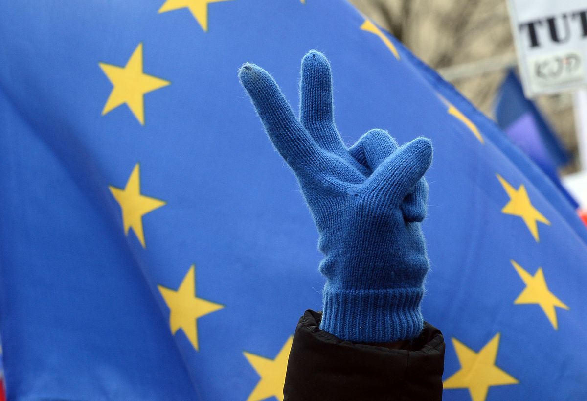 A European Union supporter shows a victory sign, with the EU flag behind as thousands march through the downtown in a show of support for the union in Warsaw, Poland, Saturday, March 25, 2017, as leaders in Rome mark the 60th anniversary of its founding treaty The rally which is being held under the slogan "I Love You, Europe," also comes as an expression of disapproval for the country's nationalist government. (AP Photo/Alik Keplicz) (AP)