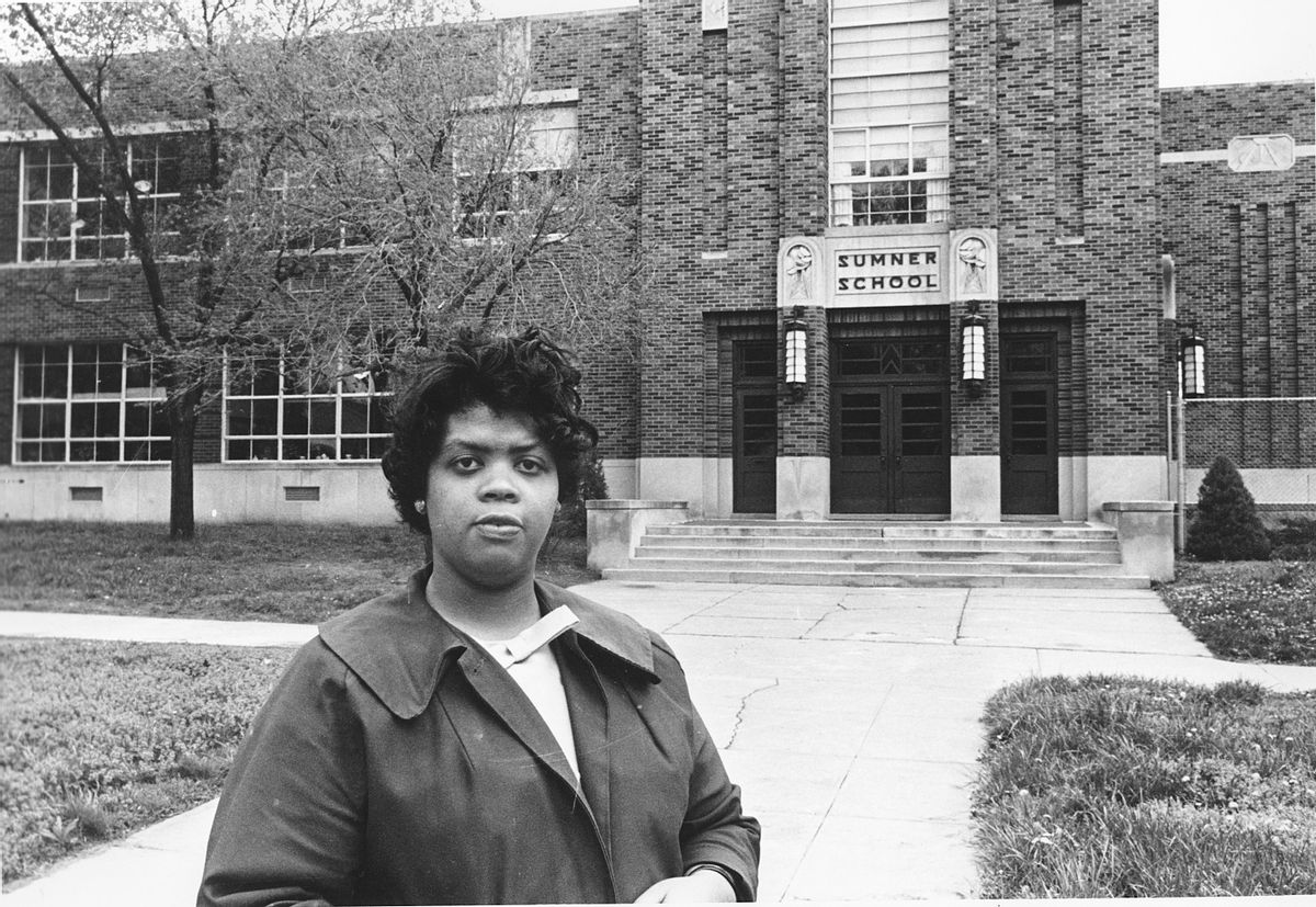 FILE - This May 8, 1964 file photo shows Linda Brown Smith standing in front of the Sumner School in Topeka, Kan. The refusal of the public school to admit Brown in 1951, then nine years old, because she is black, led to the Brown v. Board of Education of Topeka, Kansas. In 1954, the U.S. Supreme Court overruled the "separate but equal" clause and mandated that schools nationwide must be desegregated. From the time Americans roll out of bed in the morning until they turn in, and even who they might be spending the night with, the court's rulings are woven into daily life in ways large and small. (AP Photo, File) (AP)