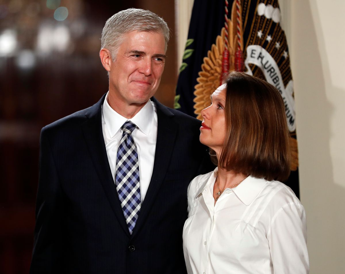 FILE - In this Jan. 31, 2017, file photo, Judge Neil Gorsuch stands with his wife Louise as President Donald Trump announces him as his choice for the Supreme Court in the East Room on the White House in Washington. Gorsuch is roundly described by colleagues and friends as a silver-haired combination of wicked smarts, down-to-earth modesty, disarming warmth and careful deliberation. His critics largely agree with that view of the self-described “workaday judge” in polyester robes. Even so, they’re not sure it’s enough to warrant giving him a spot on the court.  (AP Photo/Carolyn Kaster, File) (AP)