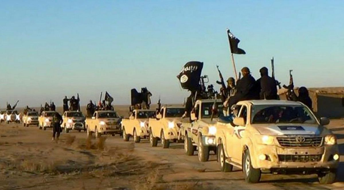 FILE - In this undated file photo released by a militant website, which has been verified and is consistent with other AP reporting, militants of the Islamic State group hold up their weapons and wave flags on their vehicles, in a convoy on a road leading to Iraq, from Raqqa, Syria.  (AP)