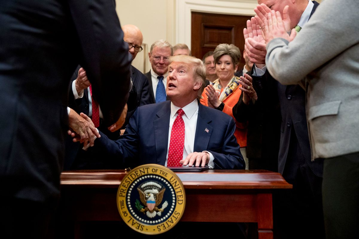 President Donald Trump signs the Waters of the United States (WOTUS) executive order, Tuesday, Feb. 28, 2017. (AP Photo/Andrew Harnik)