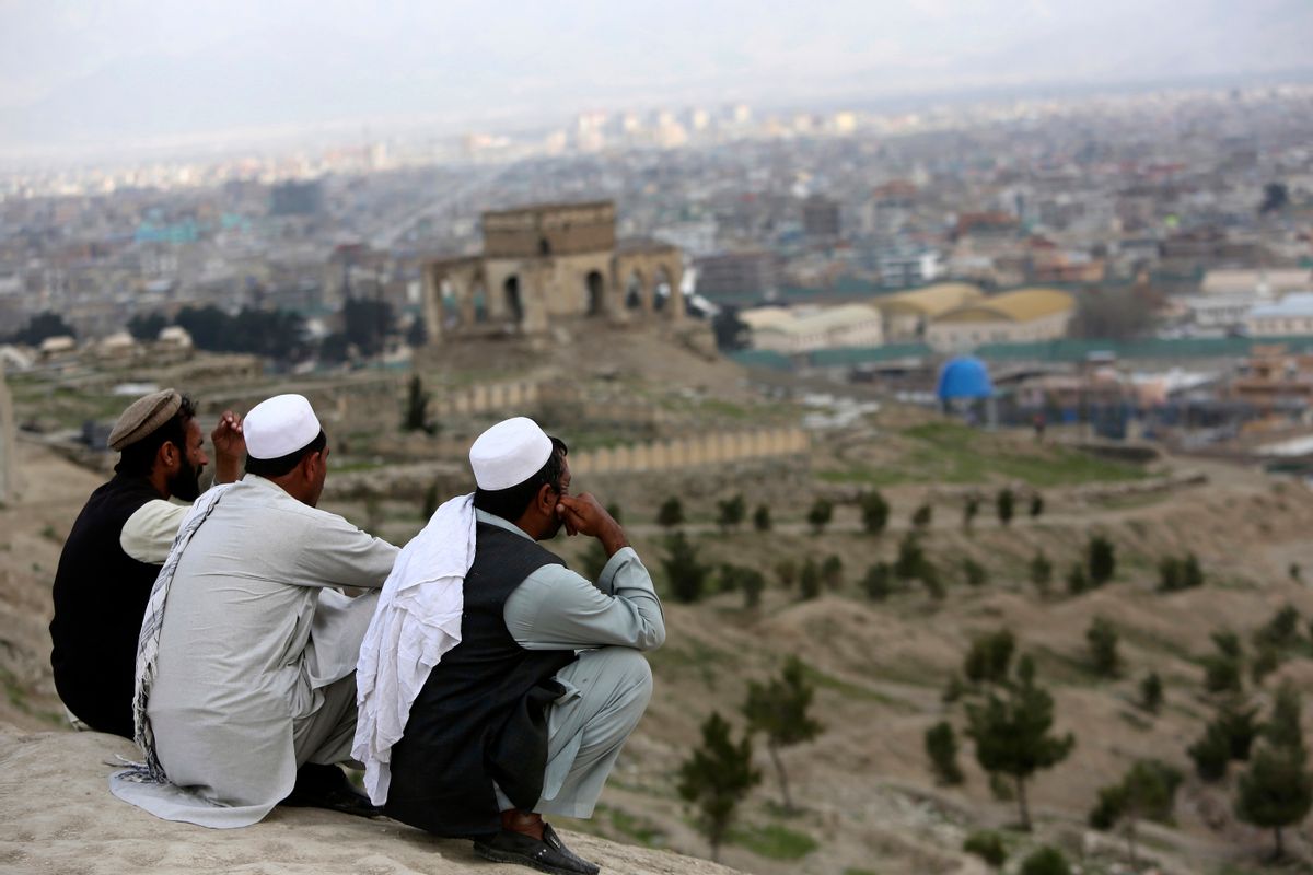 In this March 27, 2017, file photo, men sit on the Nadir Khan hilltop overlooking Kabul, Afghanistan. As America’s 16-year war in Afghanistan drags on, Russia is resurrecting its own interest in the “graveyard of empires.” The jockeying includes engaging the Taliban and leading a new diplomatic effort to tackle Afghanistan’s future, all while Washington leaves the world guessing on its strategy for ending the conflict. (AP Photo/Rahmat Gul)