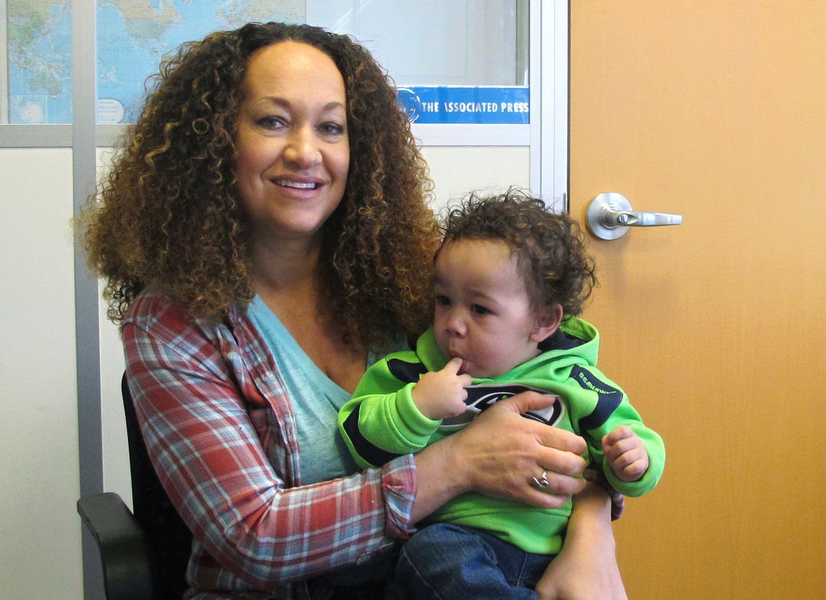 In this March 20, 2017 photo, Rachel Dolezal poses for a photo with her son, Langston in the bureau of the Associated Press in Spokane, Wash. Dolezal, who has legally changed her name to Nkechi Amare Diallo, rose to prominence as a black civil rights leader, but then lost her job when her parents exposed her as being white and is now struggling to make a living. (AP Photo/Nicholas K. Geranios) (AP)