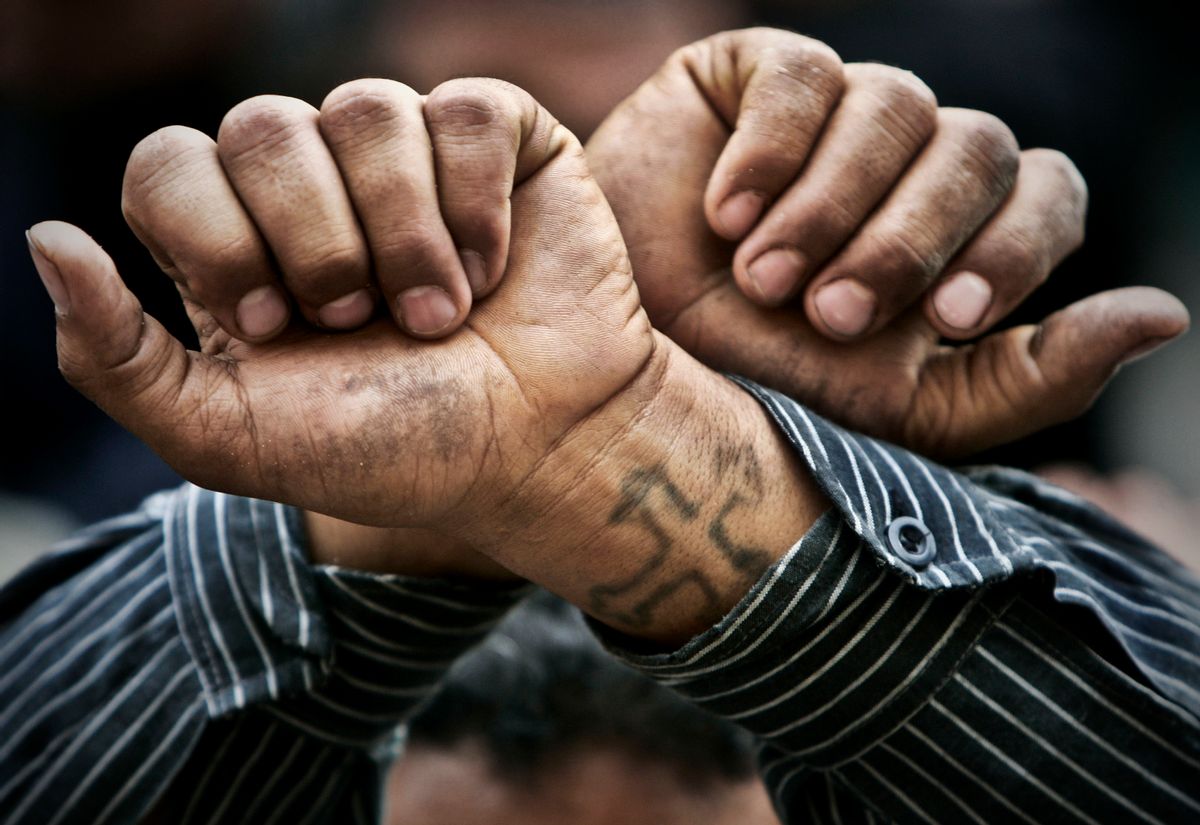 FILE - In this Friday, April 14, 2006 file photo, Egyptian Copts cross their wrists in defiance outside the Saints Church in the Sidi Bishr district of Alexandria in Egypt. Egypt’s Coptic Christians have become the preferred target of Islamic State radicals operating in the Arab world’s most populous nation, seeking to sow discord, undermine President Abdel-Fattah el-Sissi, and split the country. (AP Photo/Ben Curtis, File) (AP)