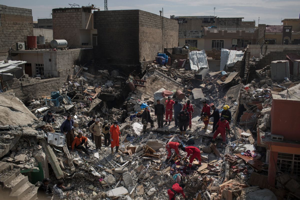 Civil protection rescue teams work on the debris of a destroyed house to recover the body of people killed in an airstrike during fighting between Iraqi security forces and Islamic State militants on the western side of Mosul, Iraq. (AP Photo/Felipe Dana, File)