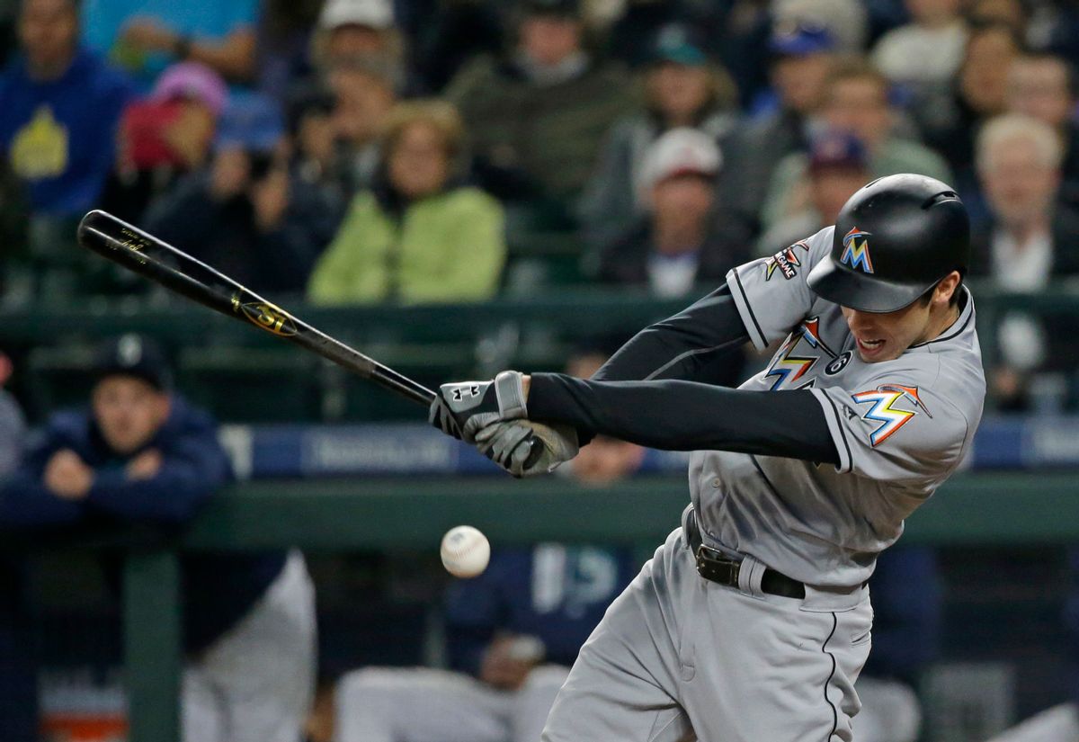 Miami Marlins' Christian Yelich hits an RBI single to score Dee Gordon in the first inning of a baseball game against the Seattle Mariners, Tuesday, April 18, 2017, in Seattle. (AP Photo/Ted S. Warren) (AP)