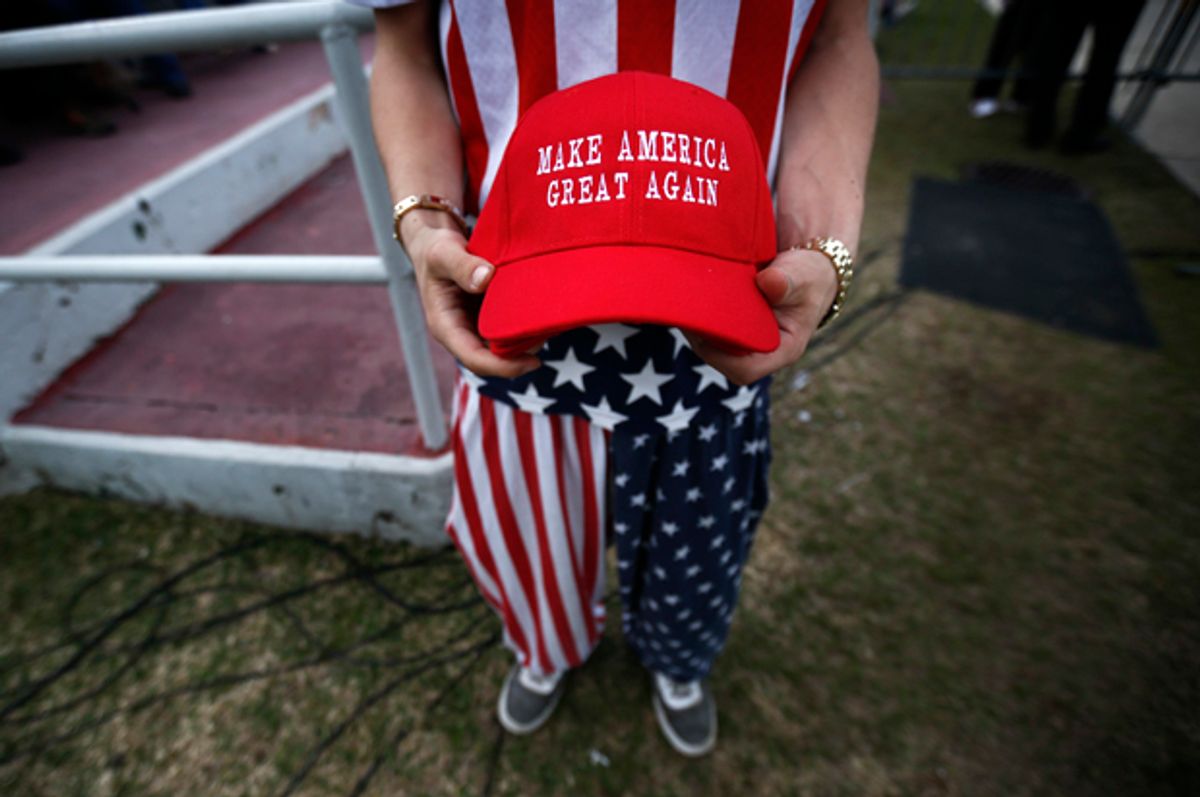A man dressed in American flag clothes holds "Make America Great Again" hats before President-elect Donald Trump speaks at a rally at the Ladd–Peebles Stadium, Saturday, Dec. 17, 2016, in Mobile, Ala. (AP Photo/Brynn Anderson) (AP/Brynn Anderson)