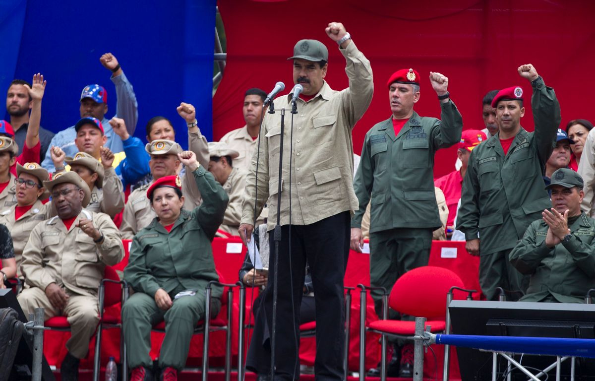 Venezuela's President Nicolas Maduro, center, leads the seventh anniversary celebration of the Bolivarian Militia, in front of the Miraflores presidential palace in Caracas, Venezuela, Monday, April 17, 2017. Officially known as the Venezuelan National Bolivarian Militia, it is a branch of the National Armed Forces of Venezuela created by the late President Hugo Chavez. The anniversary celebration took place with unrest spreading in Venezuela as confrontations between opposition demonstrators and authorities continue. (AP Photo/Ariana Cubillos) (AP)