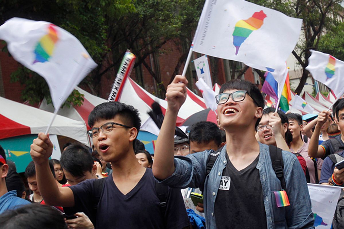 Same-sex marriage supporters wave rainbow Taiwan flags outside the Legislative Yuan in Taipei, Taiwan, May 24, 2017, after the Constitutional Court ruled in favor of same-sex marriage.   (AP/Chiang Ying-ying)