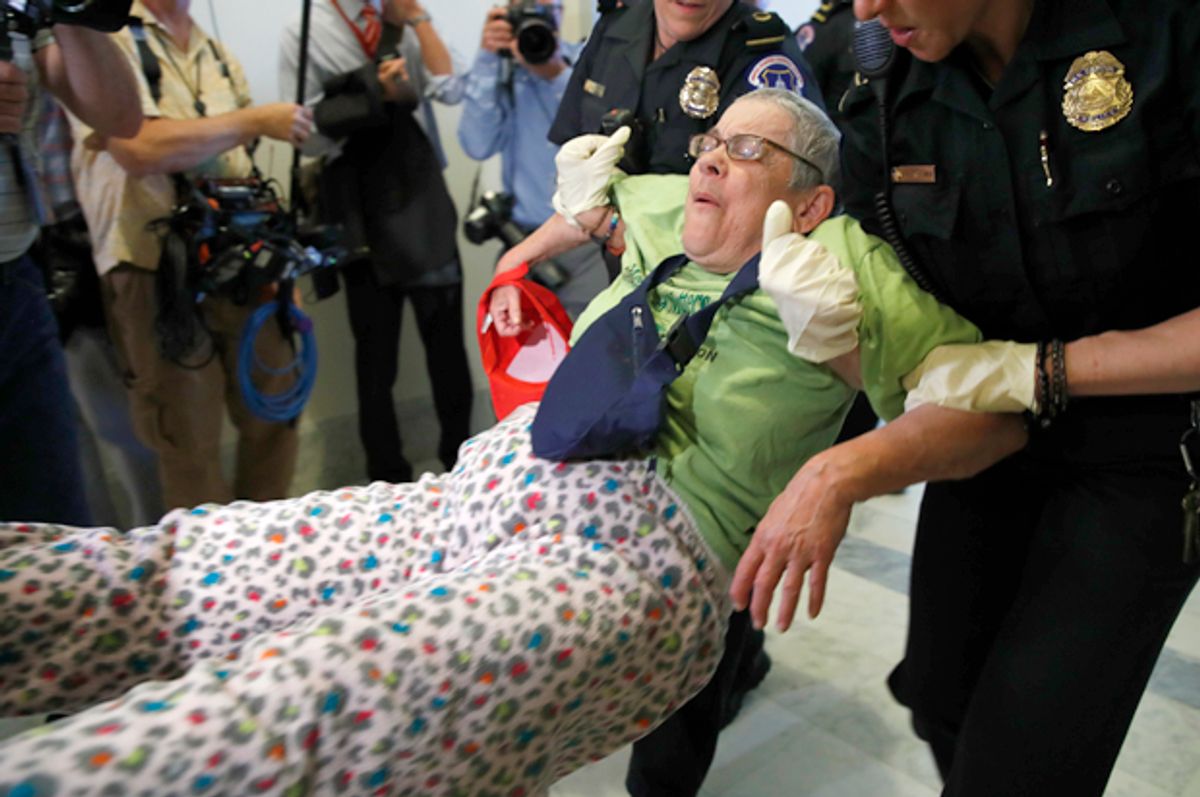 People are removed as they protest proposed cuts to Medicaid (AP/Jacquelyn Martin)
