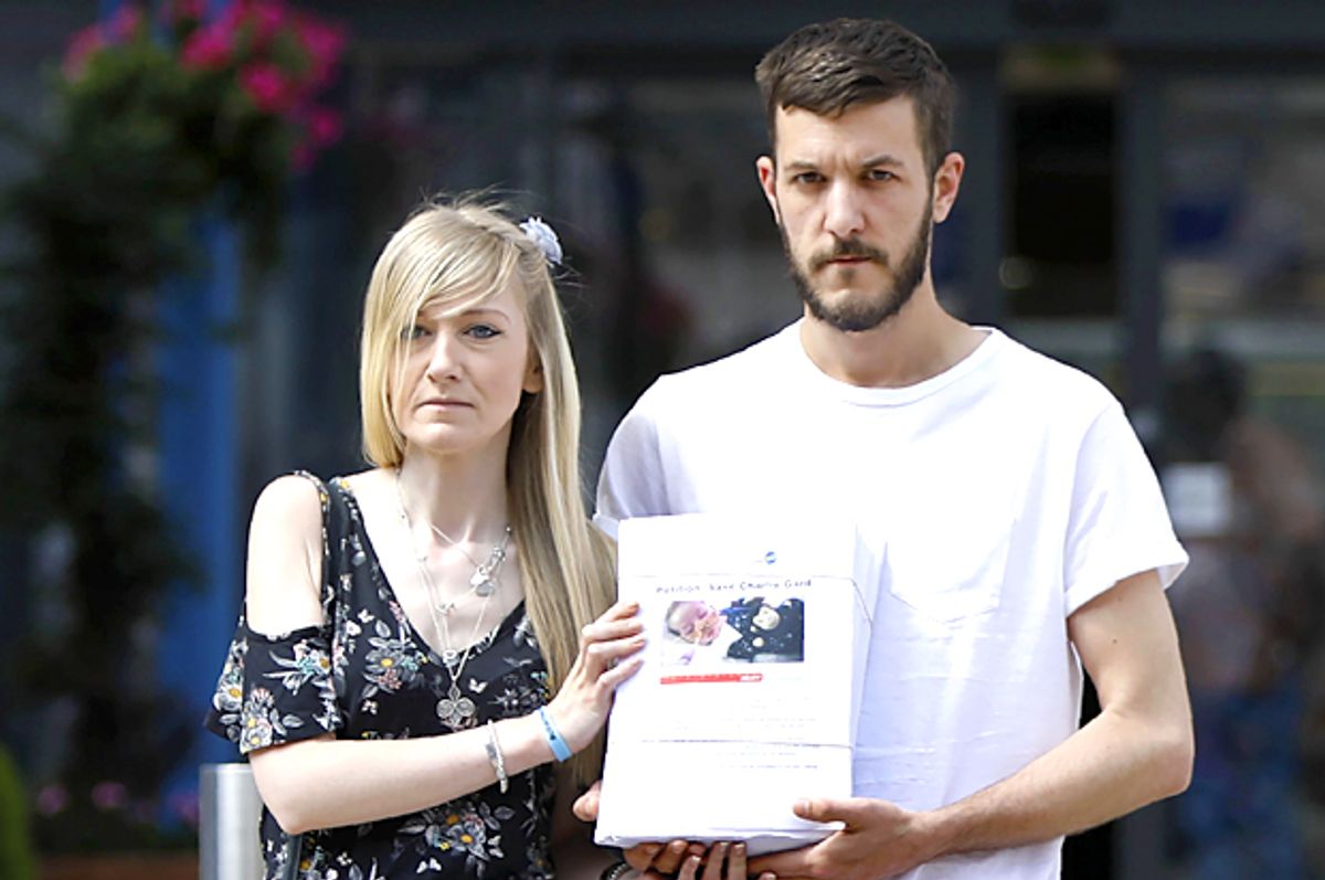 Connie Yates and Chris Gard, parents of Charlie Gard, pose with a petition of signatures supporting their case. (Getty/Tolga Akmen)