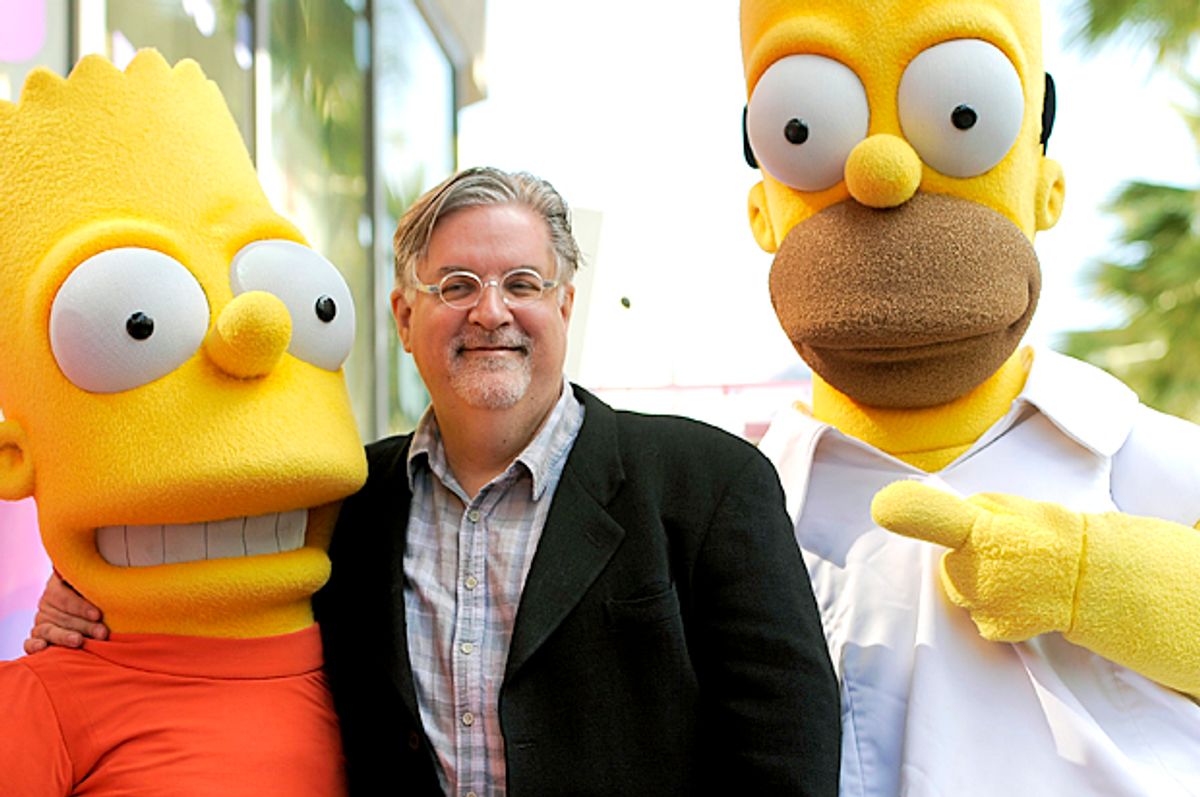 Matt Groening, creator of "The Simpsons," poses with his character creations Bart Simpson and Homer Simpson (AP/Chris Pizzello)