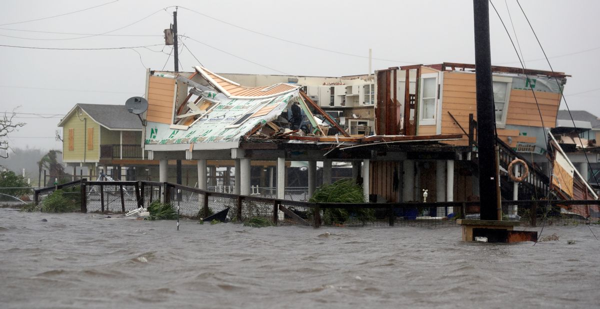 Flood water surround homes damaged by Hurricane Harvey, Saturday, Aug. 26, 2017, in Rockport, Texas.  (AP Photo/Eric Gay)