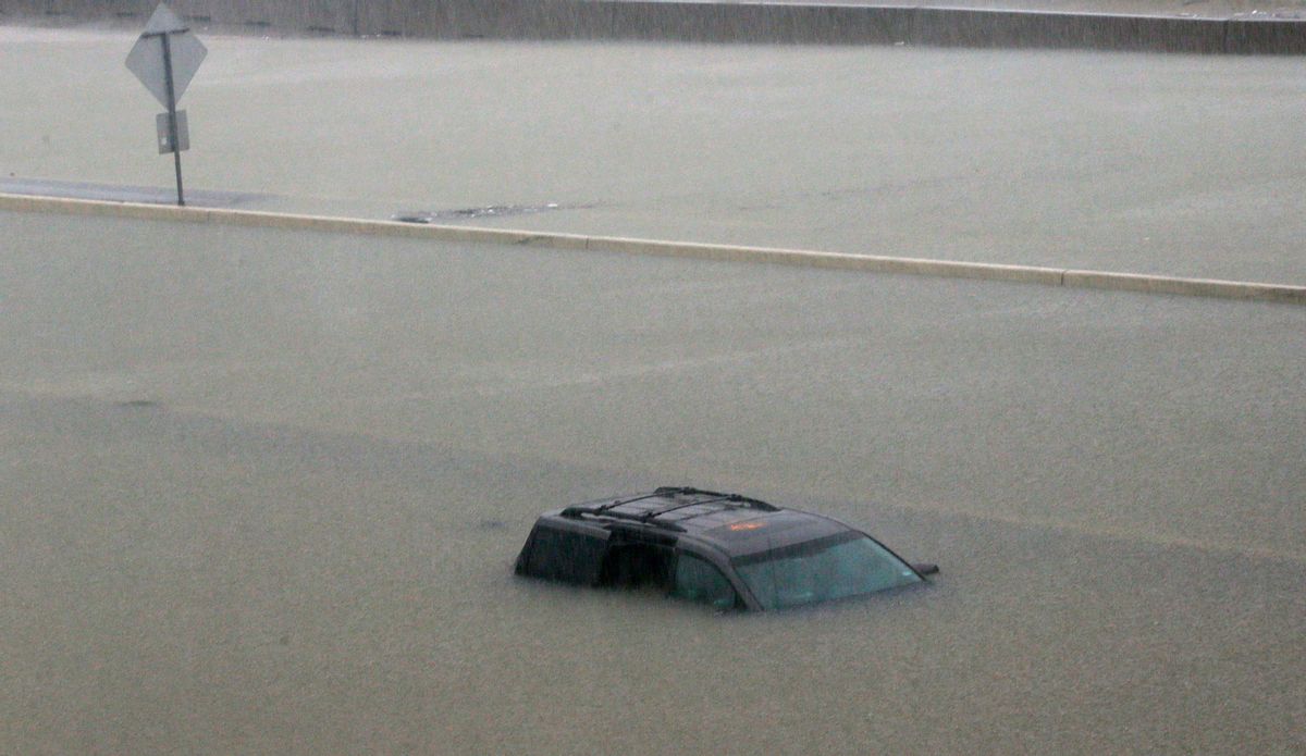 An abandoned vehicle sits in flood waters on the I-10 highway in Houston, Texas, Sunday, Aug. 27, 2017.  (AP Photo/LM Otero)