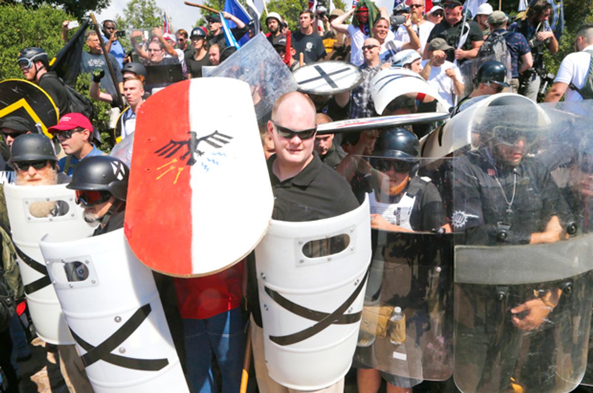 White nationalist demonstrators use shields as they guard the entrance to Lee Park in Charlottesville, Va. (AP/Steve Helber)