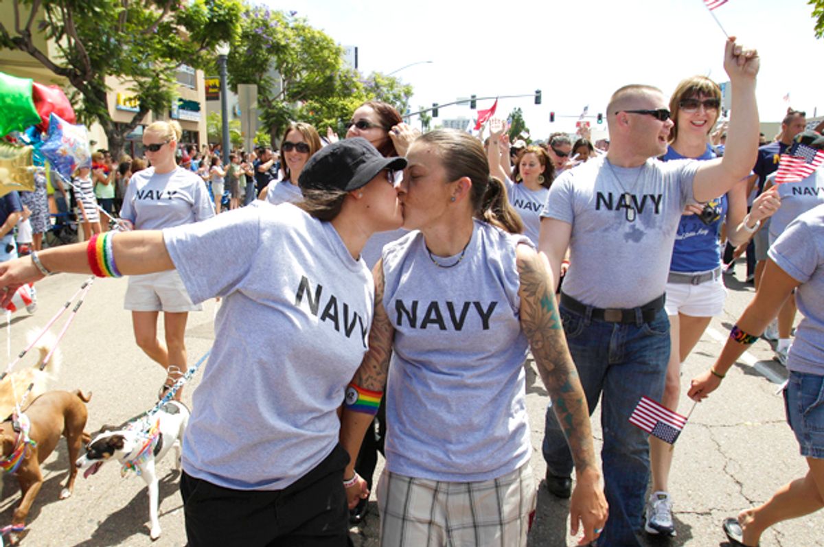 Two active duty sailors in the Navy kiss as they march in the Gay Pride Parade in San Diego (AP/Gregory Bull)