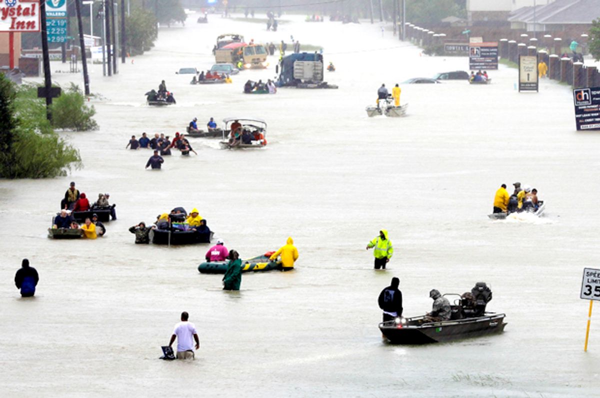 Rescue boats fill a flooded street as flood victims are evacuated. (AP/David J. Phillip)
