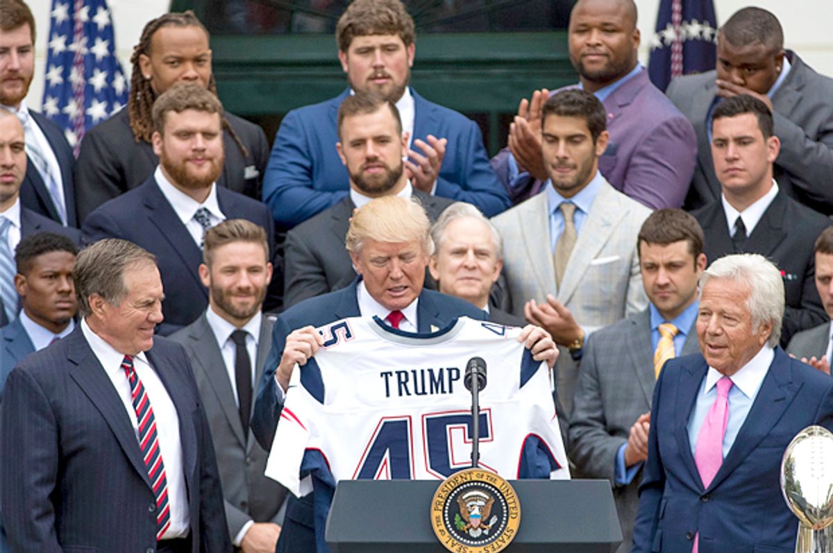 President Donald Trump is presented with a New England Patriots jersey (AP/Andrew Harnik)