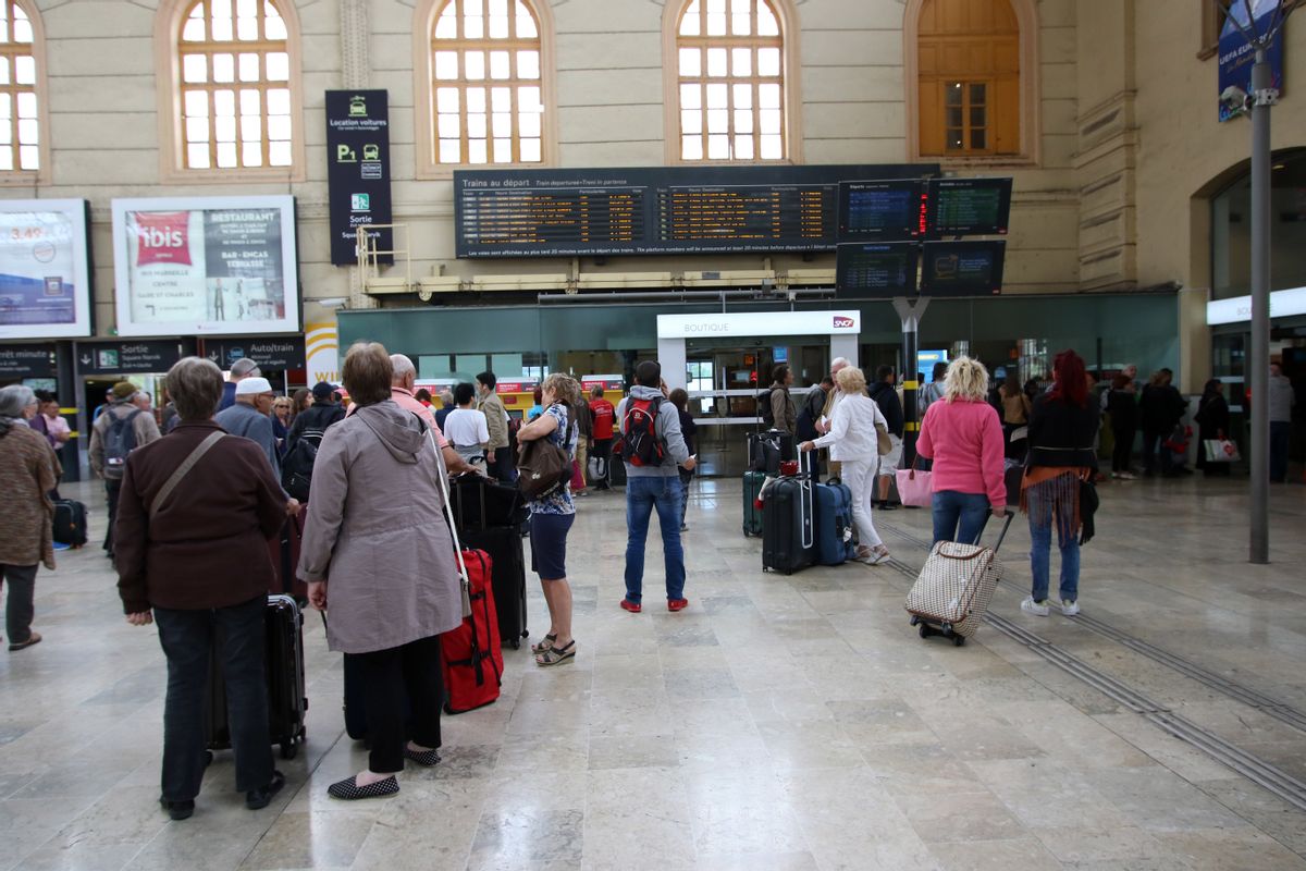 People wait to take a train, at the Saint-Charles railway station in Marseille. (AP Photo/Claude Paris)