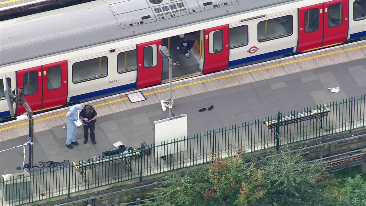 In this aerial image made from video, forensic officers work at the Parsons Green Underground Station after an explosion in London Friday, Sept. 15, 2017. A reported explosion at a train station sent commuters stampeding in panic, injuring several people at the height of London's morning rush hour, and police said they were investigating it as a terrorist attack.  (Pool via AP)