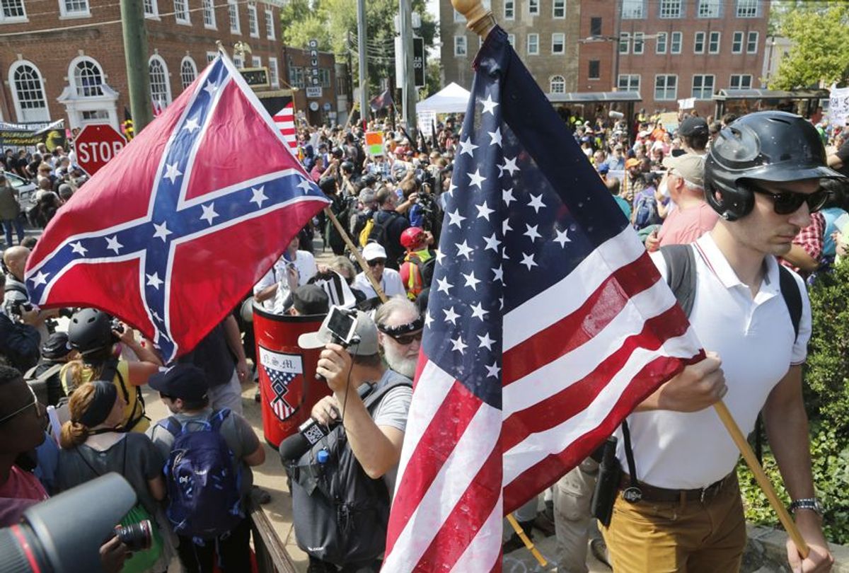 White nationalist demonstrators walk into Lee park surrounded by counter demonstrators in Charlottesville, Va., Saturday, Aug. 12, 2017. (AP/Steve Helber)