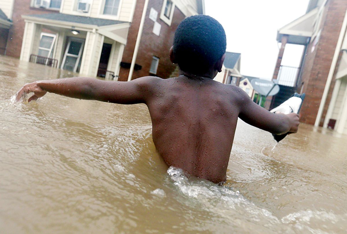 Jayveon Murphy makes his way through floodwaters from Harvey  (AP/LM Otero)