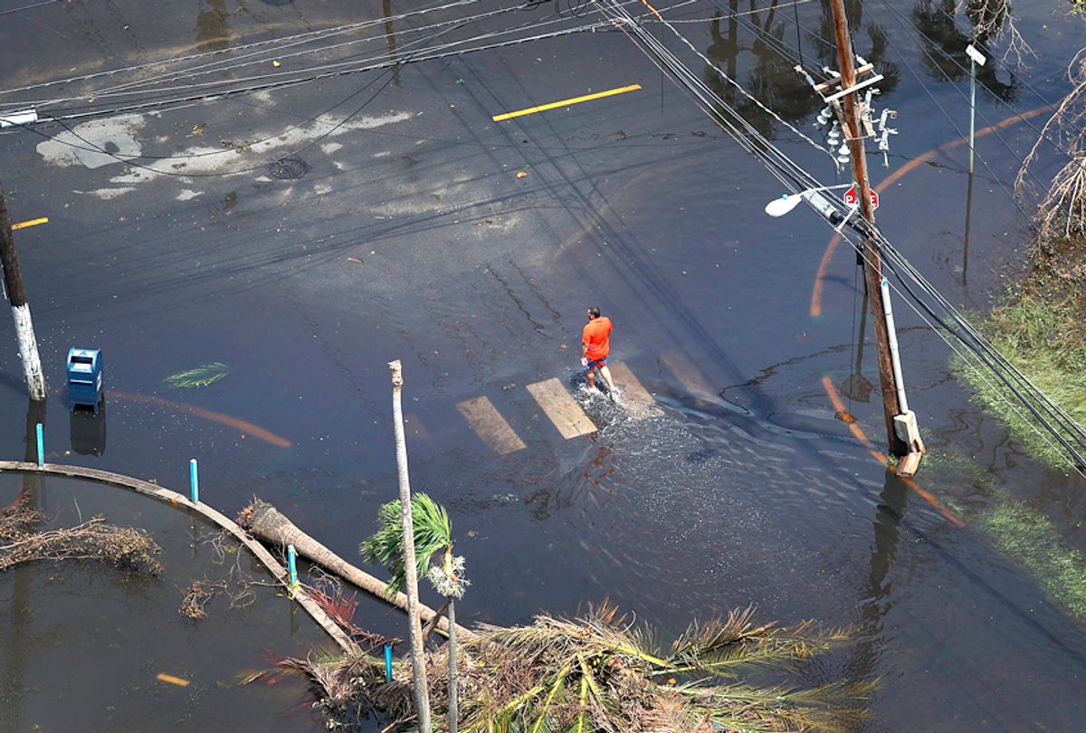 A man walks through a flooded street after Hurricane Maria in San Juan, Puerto Rico.  (Getty/Joe Raedle)