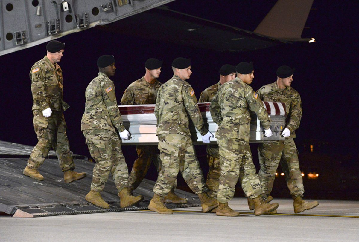 A U.S. Army carry team transfers the remains of Army Staff Sgt. Dustin Wright of Lyons, Ga., late Thursday, Oct. 5, 2017, upon arrival at Dover Air Force Base, Del. (AP/Aaron J. Jenne)
