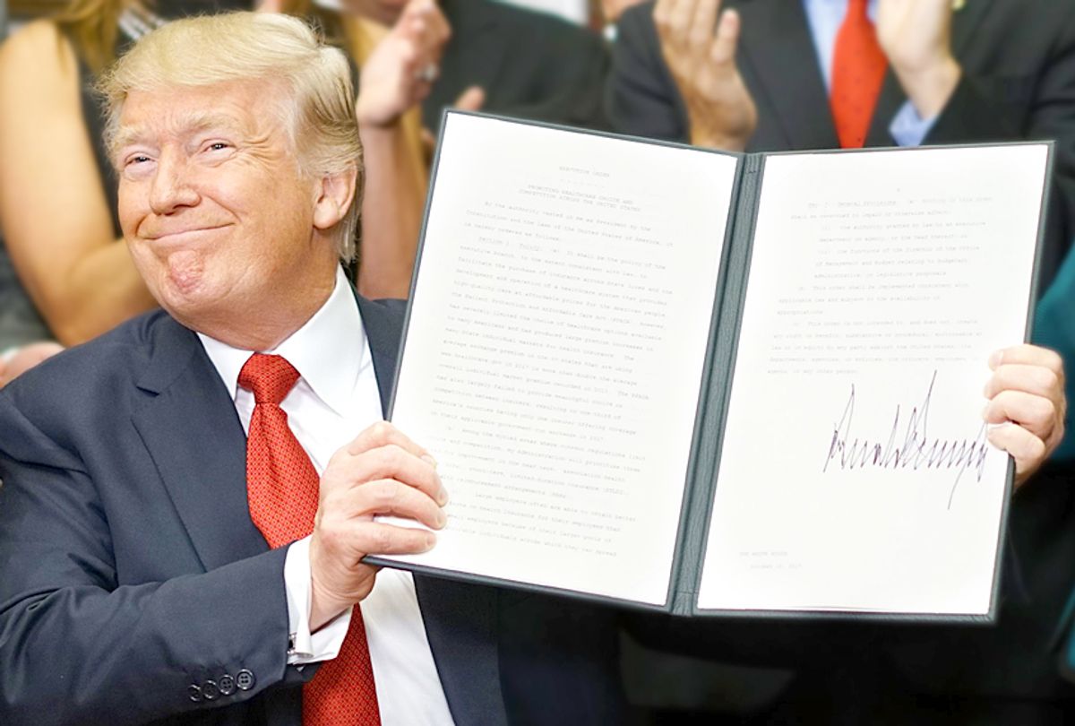 Donald Trump shows an executive order which he just signed on health insurance (Getty/Mandel Ngan)