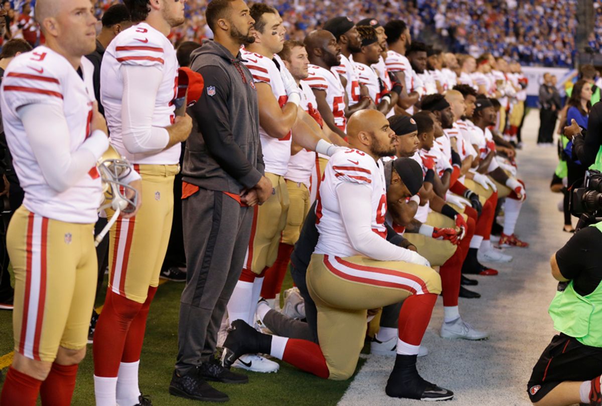 Member of the San Francisco 49ers kneel during the playing of the national anthem before an NFL football game against the Indianapolis Colts, Sunday, Oct. 8, 2017, in Indianapolis. (AP/Michael Conroy)