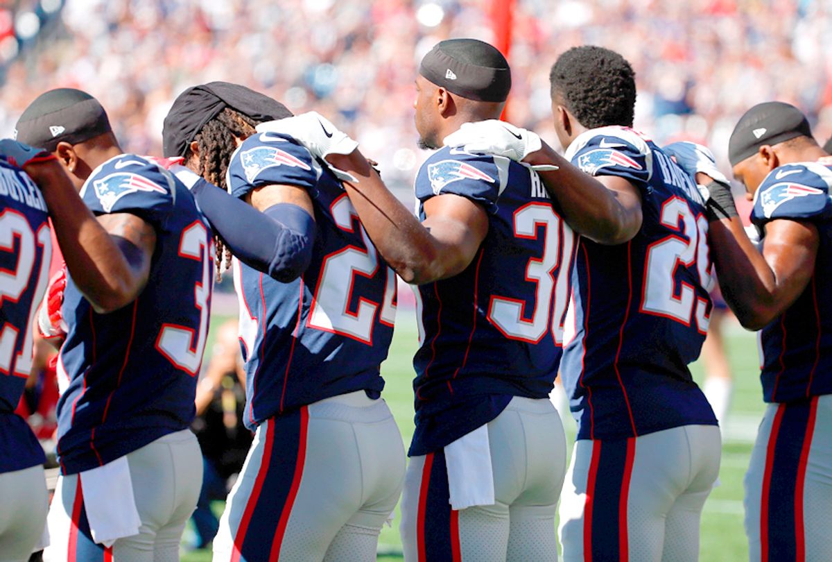 New England Patriots players stand for the national anthem (Getty/Jim Rogash)