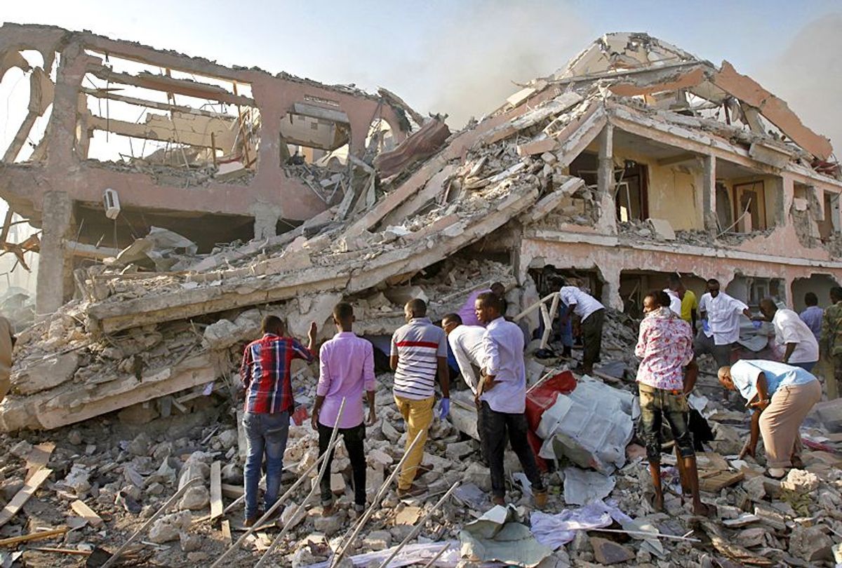 Somalis gather and search for survivors by destroyed buildings after a huge explosion from a truck bomb in the capital Mogadishu, Somalia, Oct. 14, 2017.  (AP/Farah Abdi Warsameh)