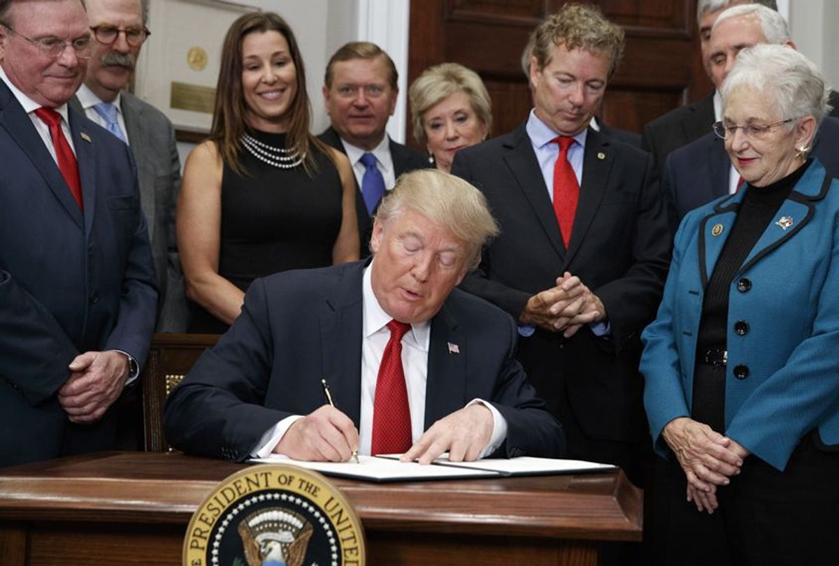 Dave Ratner, second from left, and others watch as President Donald Trump signs an executive order on health care in the Roosevelt Room of the White House, October 12, 2017. (AP/Evan Vucci)