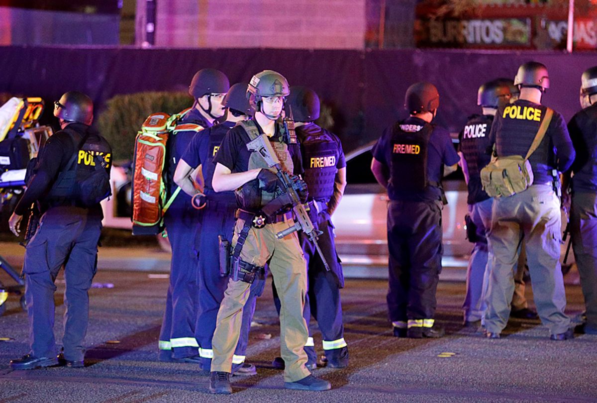 Police officers and medical personnel stand at the scene of a shooting near the Mandalay Bay resort and casino, Monday, Oct. 2, 2017 (AP/John Locher)
