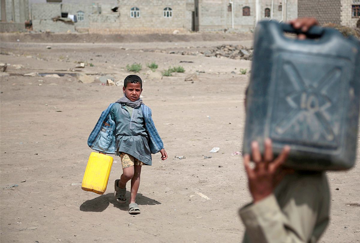 Boys carry buckets to fill with water from a well that is alleged to be contaminated water with the bacterium Vibrio cholera, on the outskirts of Sanaa, Yemen. (AP/Hani Mohammed)