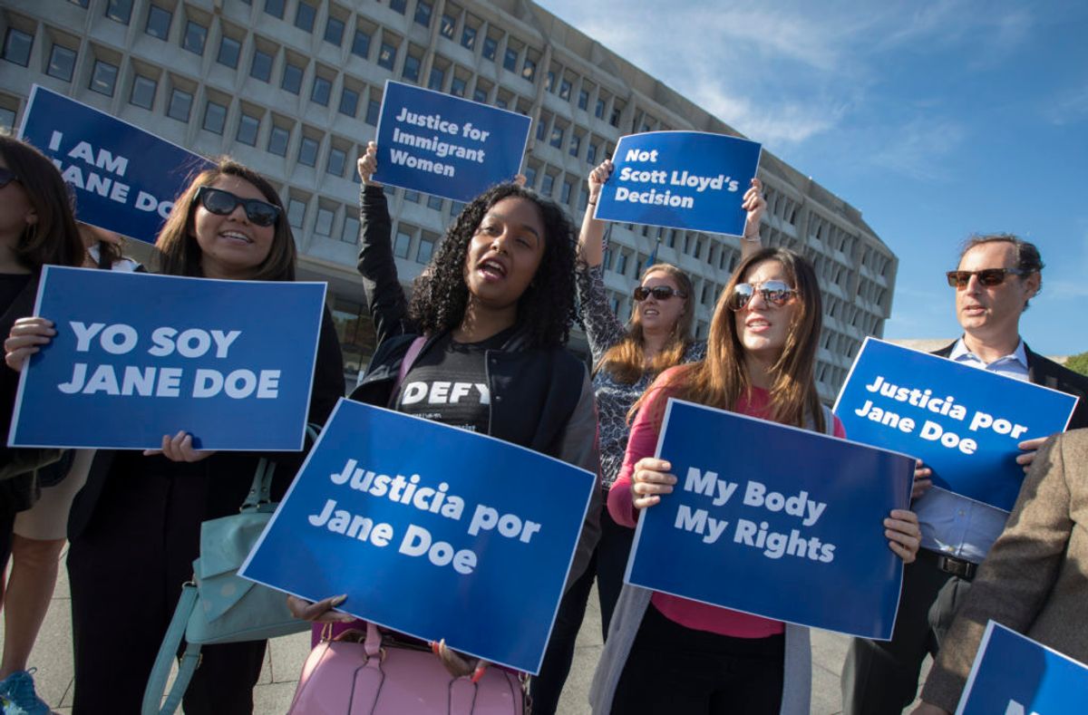 Activists with Planned Parenthood demonstrate in support of a pregnant 17-year-old being held in a Texas facility for unaccompanied immigrant children to obtain an abortion, outside of the Department of Health and Human Services in Washington, Friday, Oct. 20, 2017.  (J. Scott Applewhite/AP Photo)