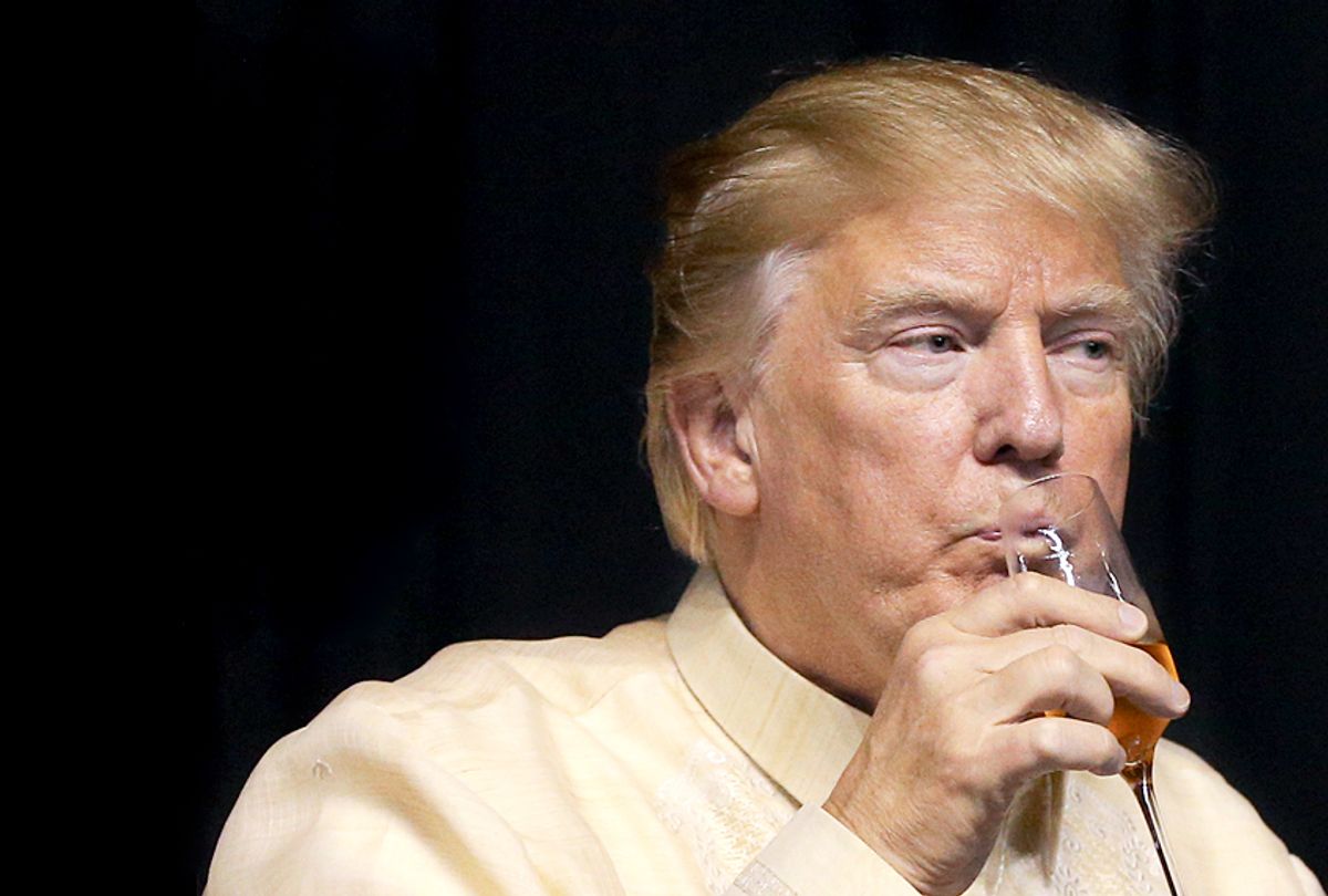 Donald Trump drinks during a special gala celebration dinner for the Association of Southeast Asian Nations. (Getty/Athit Perawongmetha)