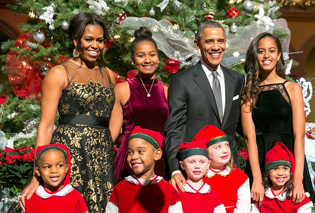 Michelle Obama, Sasha Obama, Barack Obama, and Malia Obama pose with "elves" (Getty/Kristoffer Tripplaar)