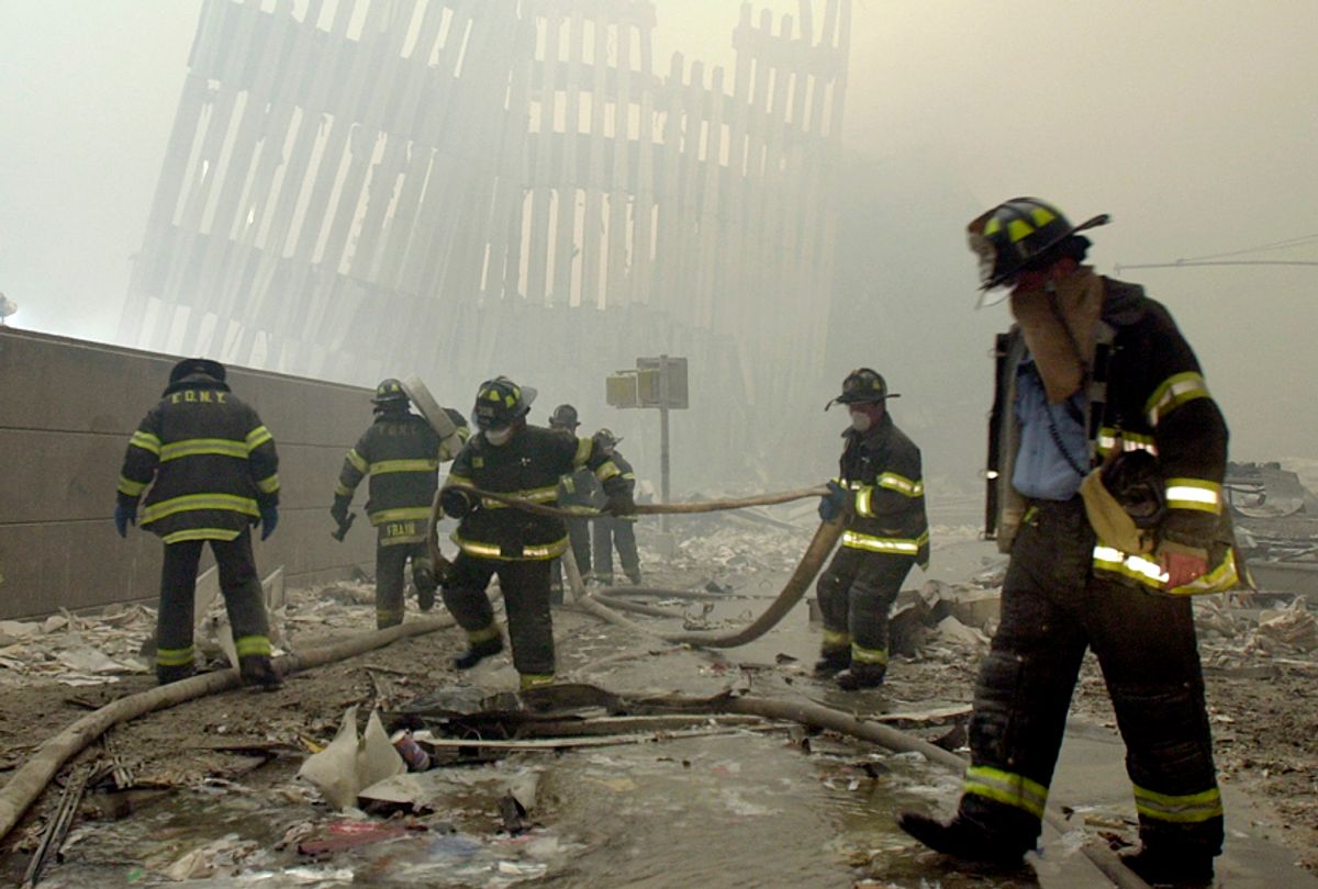 Firefighters work after the terrorist attack on the twin towers of lower Manhattan Tuesday, Sept. 11, 2001 (AP/Mark Lennihan)