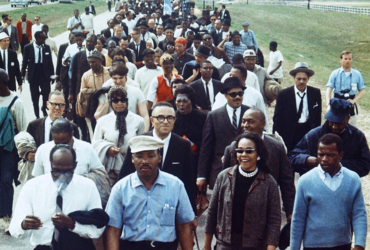 Martin Luther King Jr., flanked by his wife Coretta and John Lewis, leads a march from Selma to Montgomery, Alabama (AP)