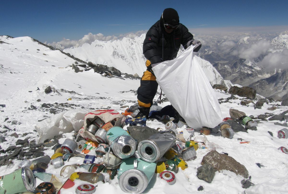 This picture taken on May 23, 2010 shows a Nepalese sherpa collecting garbage, left by climbers, at an altitude of 8,000 metres during the Everest clean-up expedition at Mount Everest. A group of 20 Nepalese climbers, including some top summiteers collected 1,800 kilograms of garbage in a high-risk expedition to clean up the world's highest peak. Led by seven-time summiteer Namgyal Sherpa, the team braved thin air and below freezing temperatures to clear around two tonnes of rubbish left behind by mountaineers, that included empty oxygen cylinders and corpses. Since 1953, there have been some 300 deaths on Everest. Many bodies have been brought down, but those above 8,000 metres have generally been left to the elements -- their bodies preserved by the freezing temperatures. The priority of the sherpas had been to clear rubbish just below the summit area, but coordinator Karki said large quantities of refuse was collected from 8,000 meters and below. AFP PHOTO/Namgyal SHERPA (Photo credit should read NAMGYAL SHERPA/AFP/Getty Images) (Afp/getty Images)