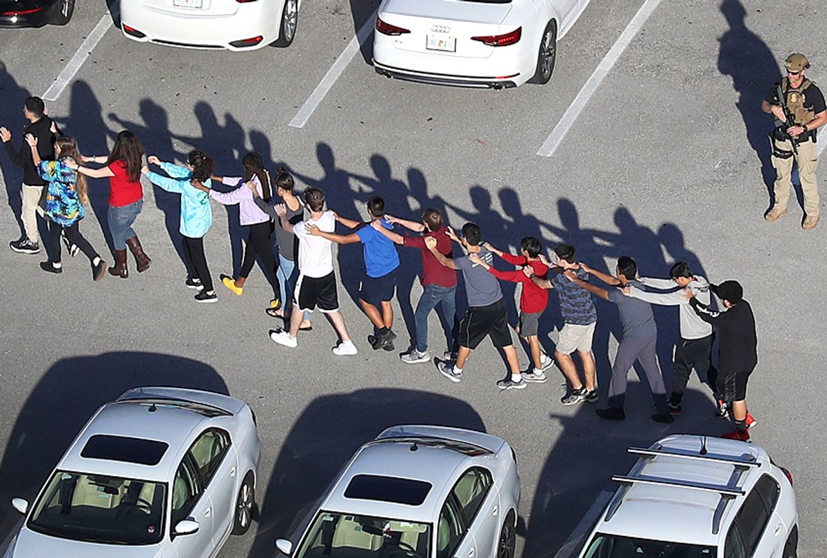 People are brought out of the Marjory Stoneman Douglas High School after a shooting at the school on February 14, 2018 in Parkland, Florida. (Getty/Joe Raedle)