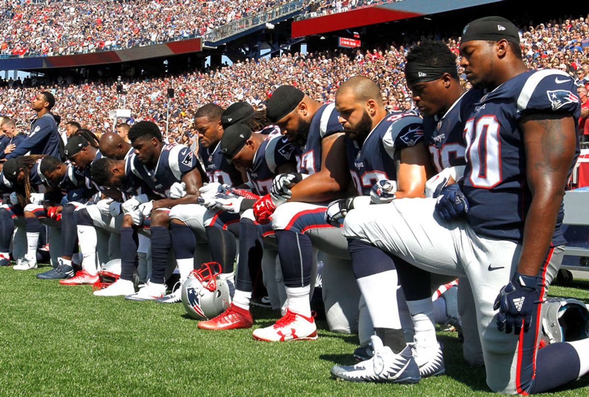 Members of the New England Patriots kneel during the National Anthem (Getty/Jim Rogash)