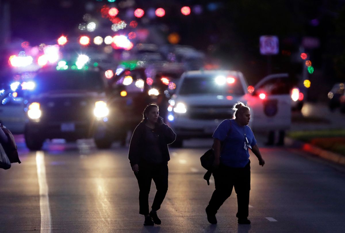 People evacuate as emergency vehicles stage near the site of another explosion, March 20, 2018, in Austin, Texas.  (AP/Eric Gay)