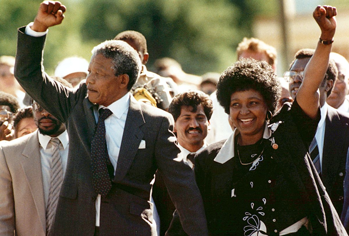 Nelson Mandela and his wife Winnie walk from the Victor Verster prison near Cape Town, South Africa, Feb. 11, 1990. (AP/Greg English)