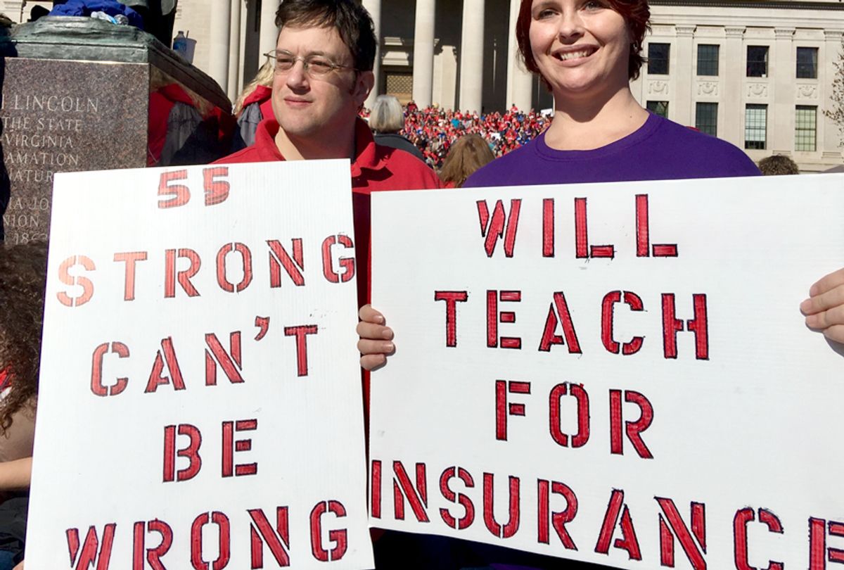 Teachers hold signs at a rally in Charleston, W.Va., Feb. 26, 2018.  (AP/John Raby)